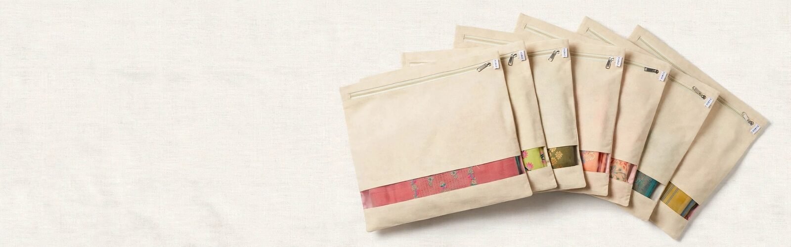 Cream fabric saree storage pouches with clear window and zipper closure